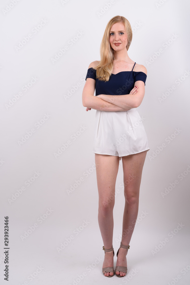 Naklejka premium Young beautiful British woman with blond hair against white background