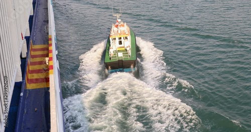 Top dow footage of a Pilot boat Moving away from a Ship after action. photo