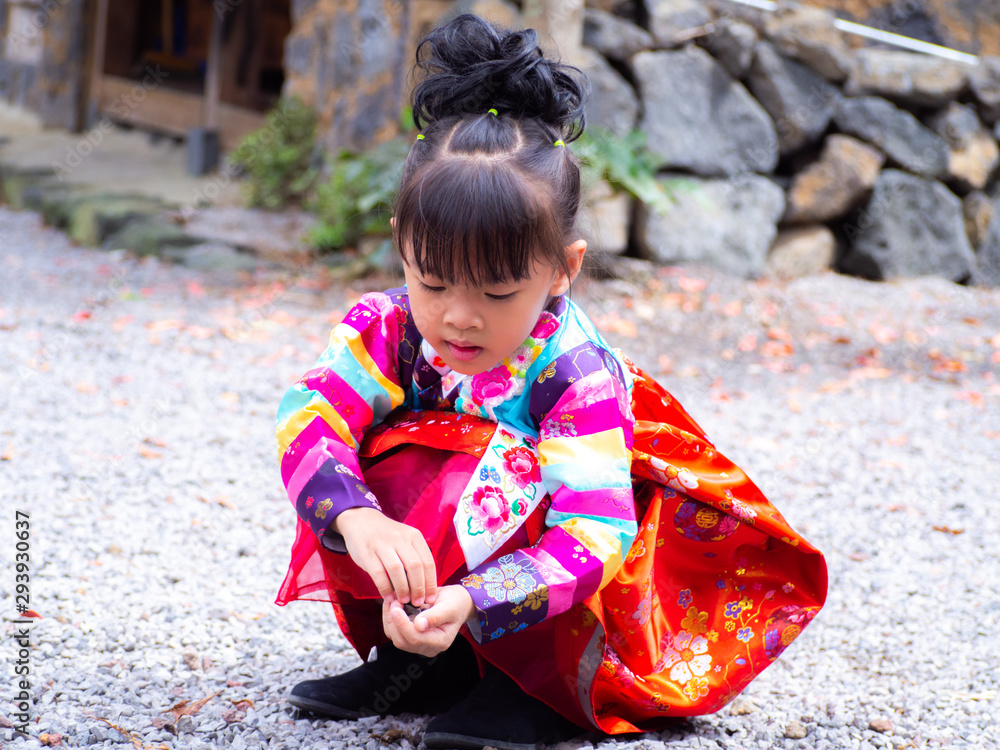 Asian little girl wearing a Korean Traditional Hanbok dress at Ancient village Asian little girl wearing a Korean Traditional Hanbok dress at Ancient village