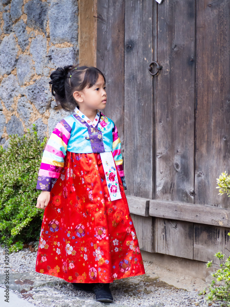 Asian little girl wearing a Korean Traditional Hanbok dress  at Ancient village