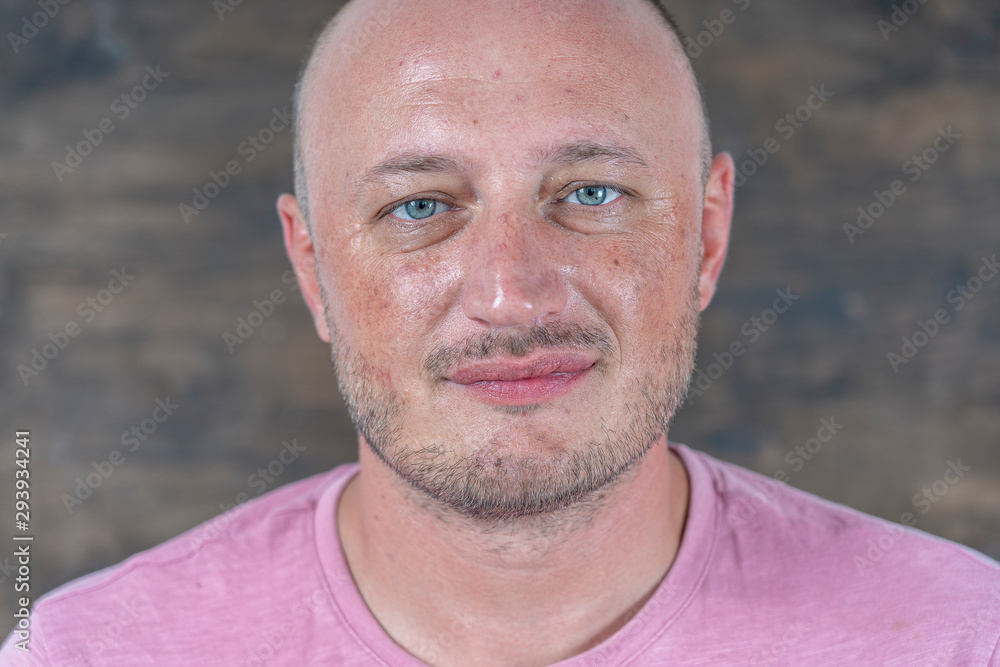 Portrait of middle-aged caucasian bald man looking straight at camera, close up Portrait of middle-aged caucasian bald man looking straight at camera, close up