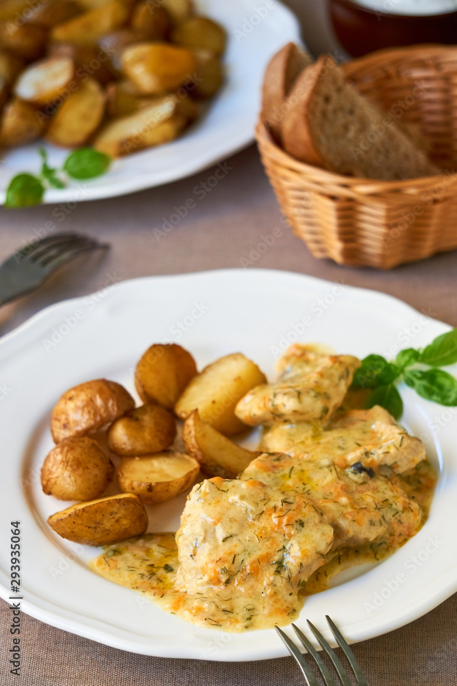 Stewed pork in creamy sauce with baked potatoes