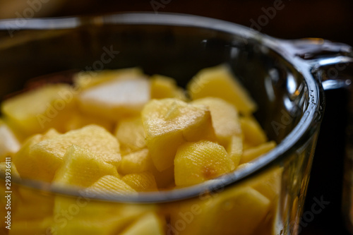 sliced and peeled apples inside a glass measuring cup