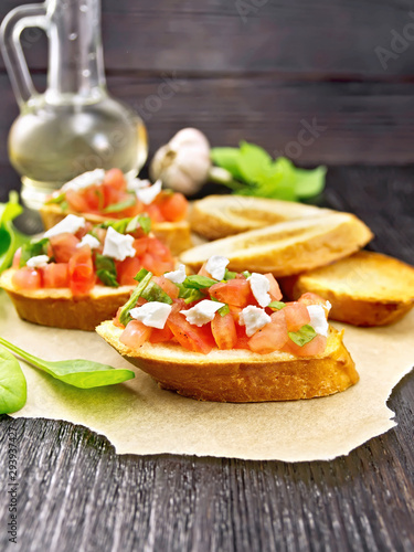 Bruschetta with tomato and cheese on parchment