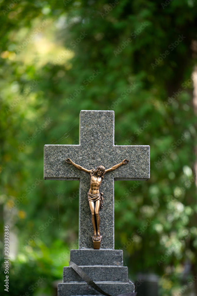 Jesus Christ cross with green background at cemetery
