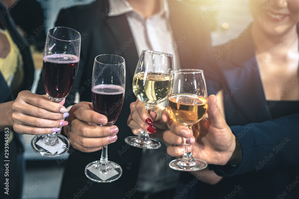 New year's eve celebration party - group of people clinking beverage glasses together at the party.