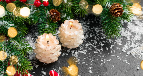 Christmas background with festive decoration, candles and fir tree branches.