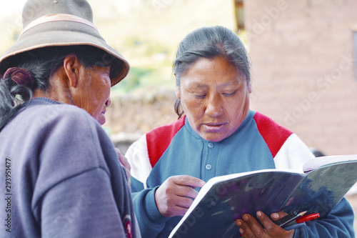 Two native american women holding a textbook. Education for adults. photo