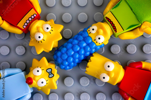 Fotografija Tambov, Russian Federation - May 20, 2018 Four Lego Simpsons minifigures - Marge, Bart, Lisa, and Maggie, on gray background