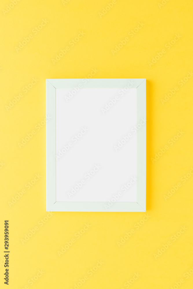 Empty picture frame on yellow wall. Mockup with copyspace Empty picture frame on yellow wall. Mockup with copyspace