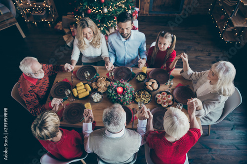 Top above and high angle view photo of large family having gathered to spend new year together grandchildren grandparents son and daughter wife husband hold each other hand praying senior mature young
