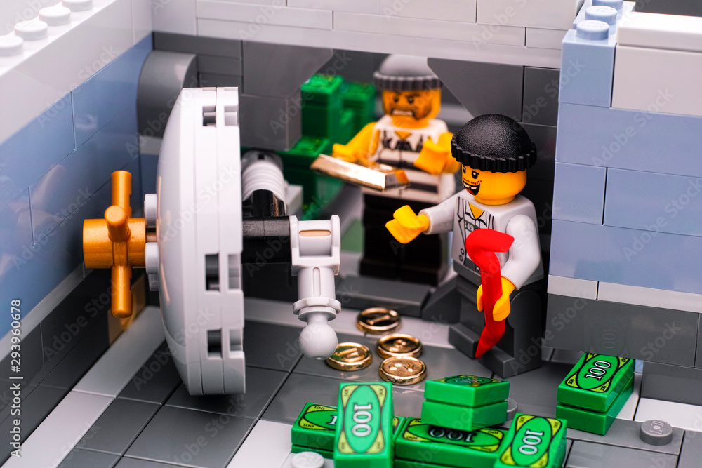 Tambov, Russian Federation - January 08, 2017 Lego bank burglary. Two broke door of bank vault and take out money and gold. Studio shot. Stock Photo | Adobe Stock