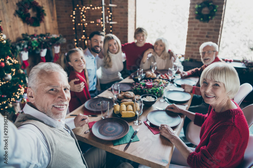 Self-portrait photo of nice lovely cheerful big full family generation gathering spending winter day eating brunch tradition in modern industrial loft brick style interior decorated house indoors