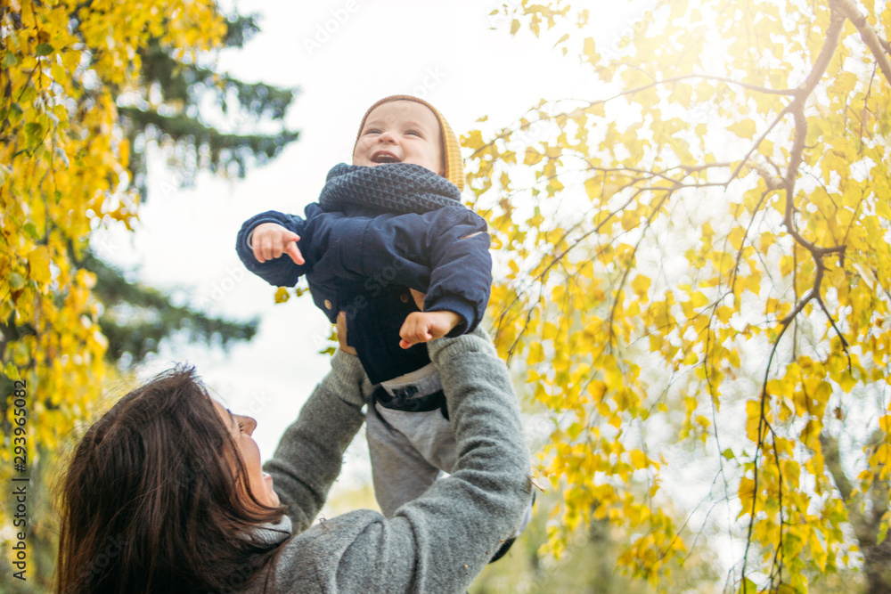 Portrait of happy mother with baby boy in autumn park Portrait of happy mother with baby boy in autumn park