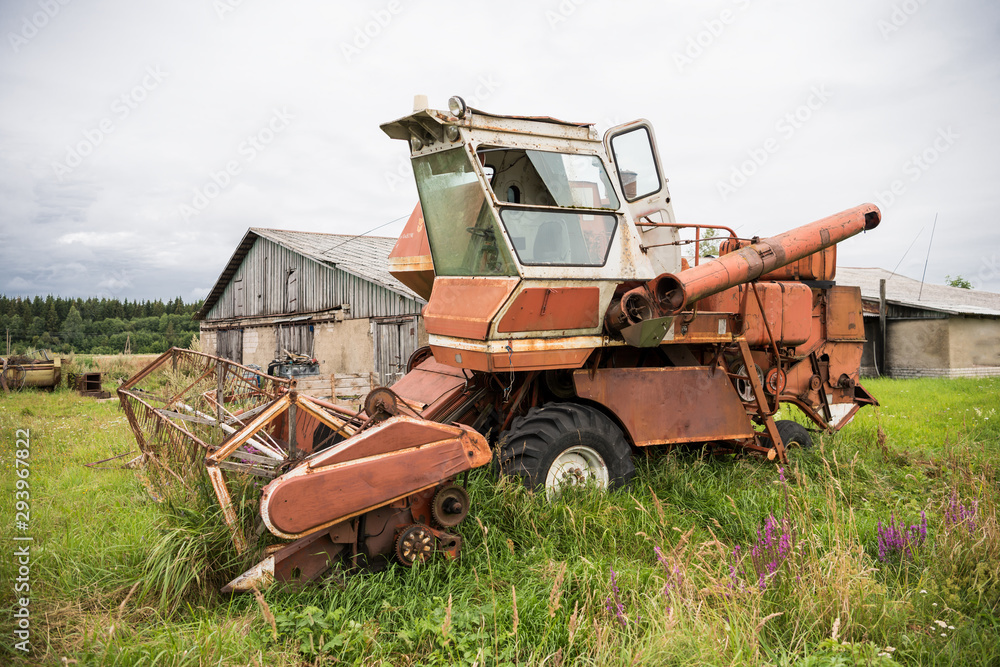 Fototapeta premium Old grain harvester in the field