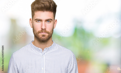 Young handsome man skeptic and nervous, frowning upset because of problem. Negative person.