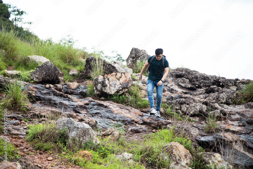 Man backpacker hiking in mountains alone outdoor. adventure active summer vacations outdoor rocky mountains on background