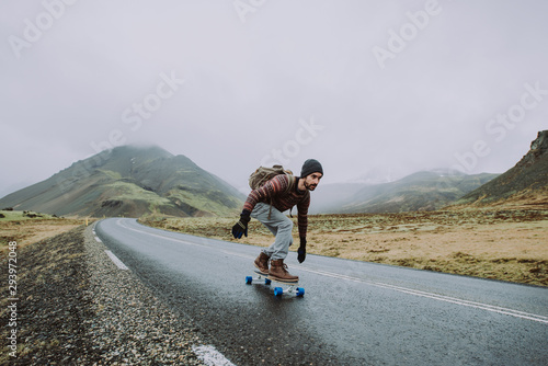 Skater traveling iceland on his longboard photo