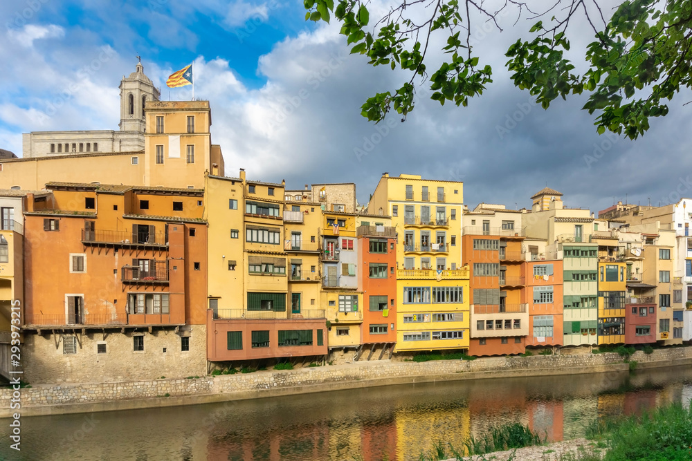 Girona colorful houses district, buildings reflected in water in river Onyar. Catalonia Spain.