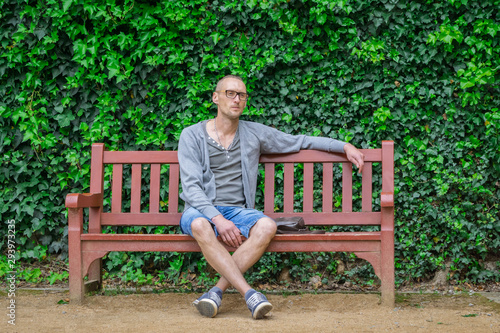 Lonely man sitting alone on bench and thinking. Loneliness concept photo