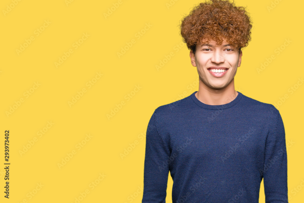 Young handsome man with afro hair with a happy and cool smile on face. Lucky person. Young handsome man with afro hair with a happy and cool smile on face. Lucky person.