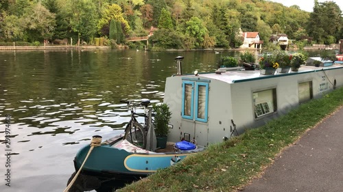 Typical narrow boat moored at the river in England