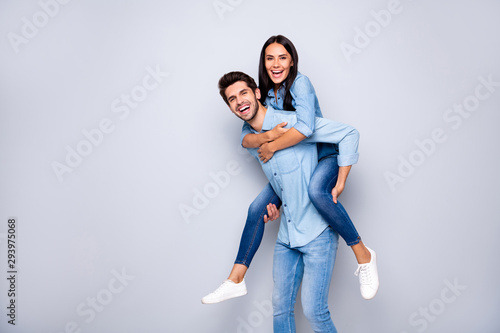 Profile photo of funny guy and lady holding piggyback playing leisure game rejoicing wear casual jeans clothes isolated grey color background photo