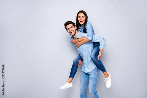 Profile photo of funny guy and lady holding piggyback playing leisure game rejoicing wear casual jeans clothes isolated grey color background