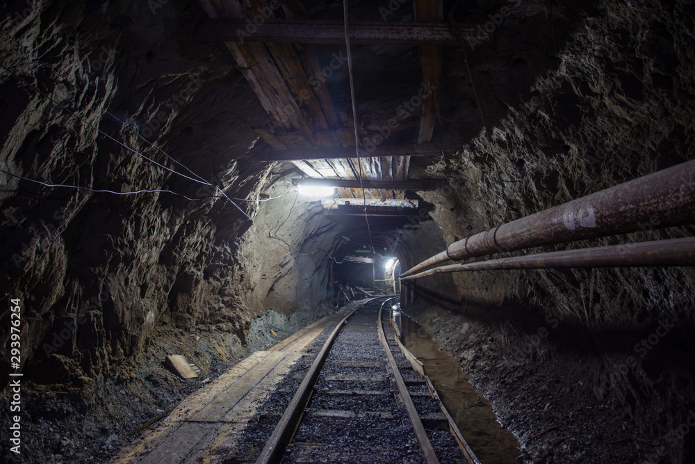 Naklejka premium Gold mine ore shaft tunnel with rails