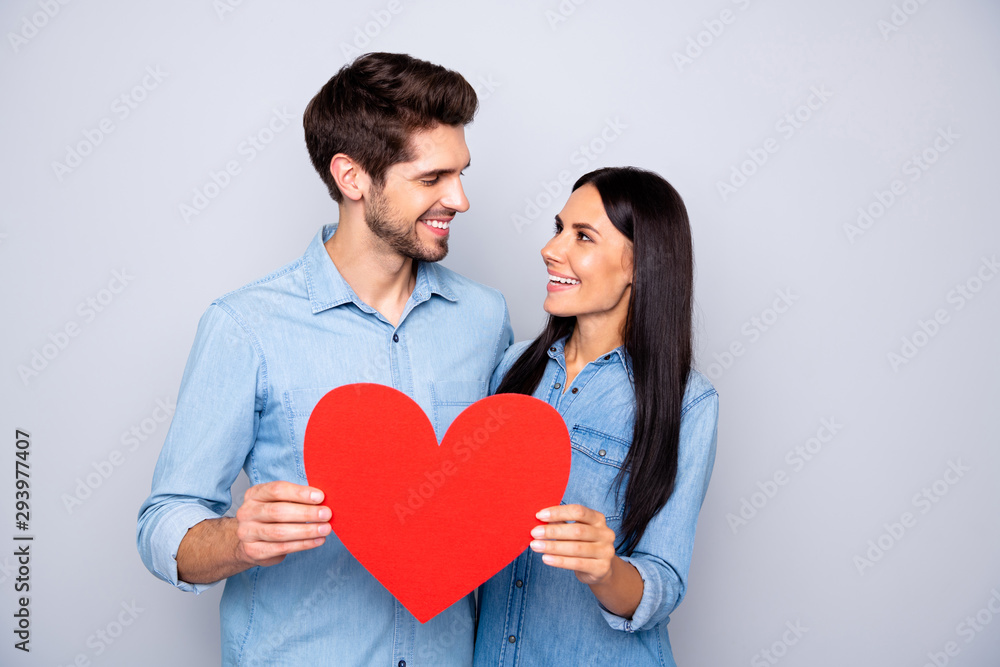 Portrait of his he her she nice-looking attractive charming lovely lovable tender cheerful cheery couple holding in hands heart 14 February isolated over light white gray pastel color background