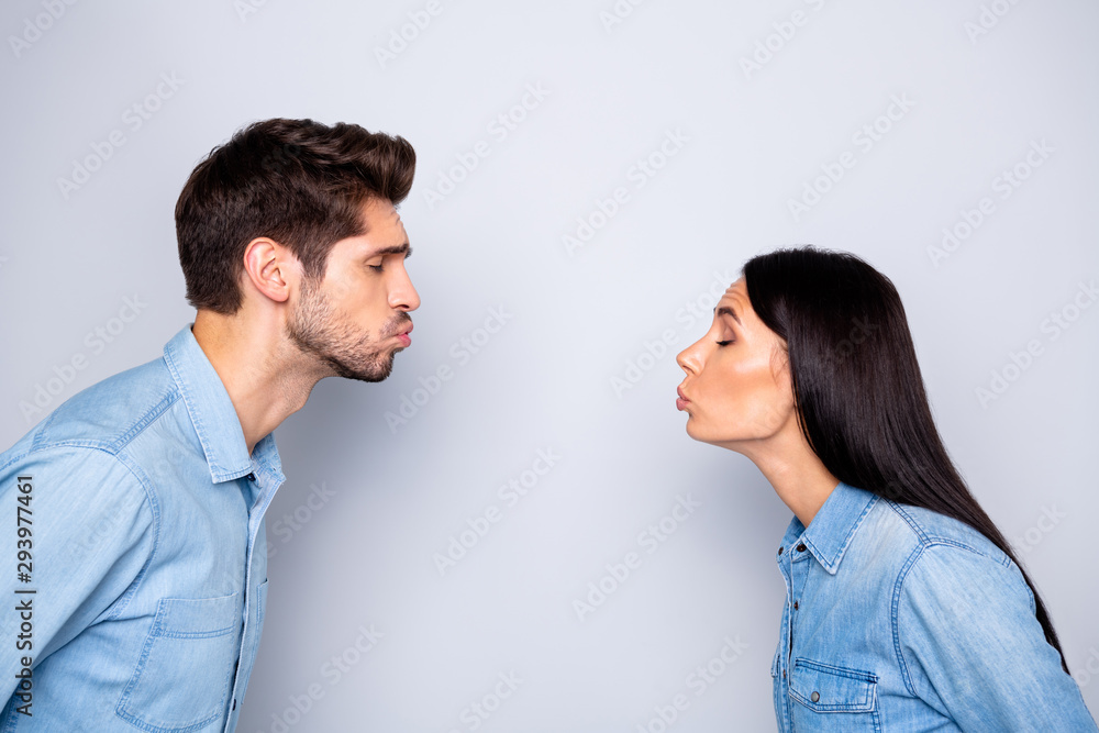 Close-up profile side view portrait of his he her she nice attractive charming lovely dreamy sweet gentle tender peaceful brunet couple kissing isolated over light white gray pastel color background Close-up profile side view portrait of his he her she nice attractive charming lovely dreamy sweet gentle tender peaceful brunet couple kissing isolated over light white gray pastel color background