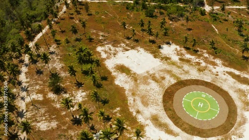 Helipad on a tropical island. Balabac, Palawan, Philippines. Helipad among the palm trees on a tropical island, top view. photo