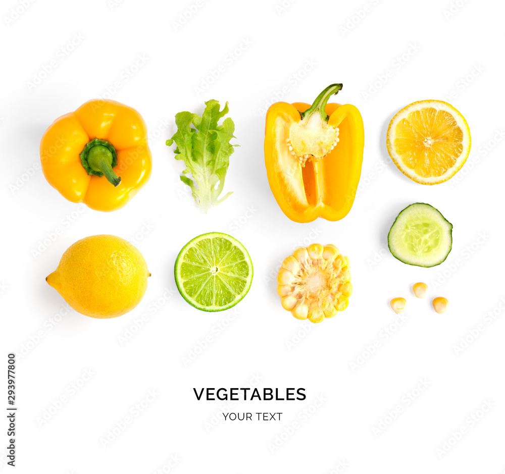 Creative layout made of yellow pepper, lemon, lime, corn and lettuce. Flat lay. Food concept. Yellow vegetables isolated on white background.
