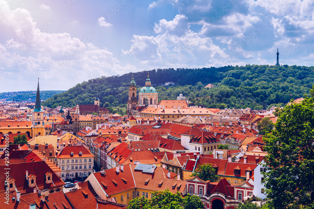 Obraz premium Top view to red roofs skyline of Prague city, Czech Republic. Aerial view of Prague city with terracotta roof tiles, Prague, Czechia. Old Town architecture with terracotta roofs in Prague.