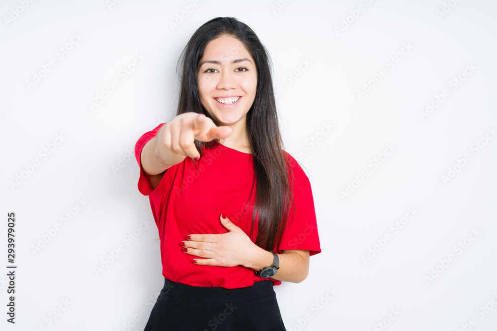 Beautiful brunette woman wearing red t-shirt over isolated background Laughing of you, pointing to the camera with finger hand over chest, shame expression Beautiful brunette woman wearing red t-shirt over isolated background Laughing of you, pointing to the camera with finger hand over chest, shame expression