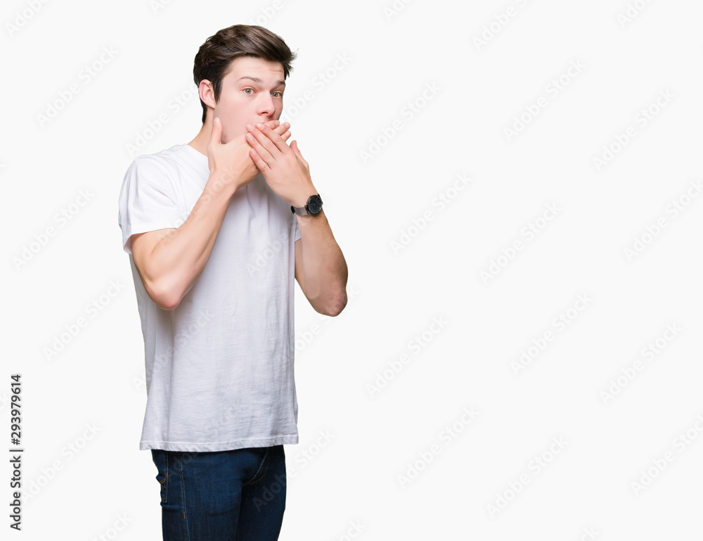 Young handsome man wearing casual white t-shirt over isolated background shocked covering mouth with hands for mistake. Secret concept. Young handsome man wearing casual white t-shirt over isolated background shocked covering mouth with hands for mistake. Secret concept.