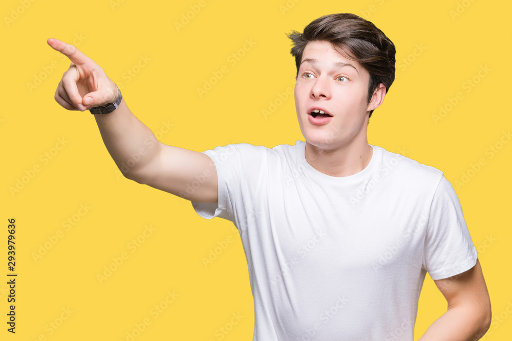 Young handsome man wearing casual white t-shirt over isolated background Pointing with finger surprised ahead, open mouth amazed expression, something in front Young handsome man wearing casual white t-shirt over isolated background Pointing with finger surprised ahead, open mouth amazed expression, something in front