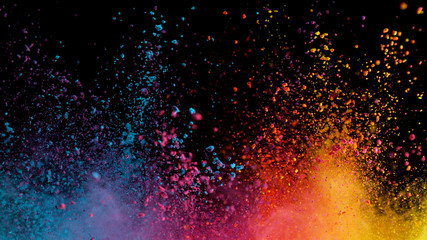 Explosion of colored powder on black background