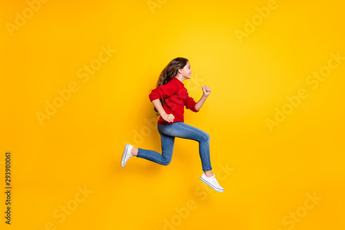 Full size photo of positive cheerful dreamy wavy curly hair model kid jump run hurry want winter seasonal discounts wear stylish trendy isolated over yellow color background