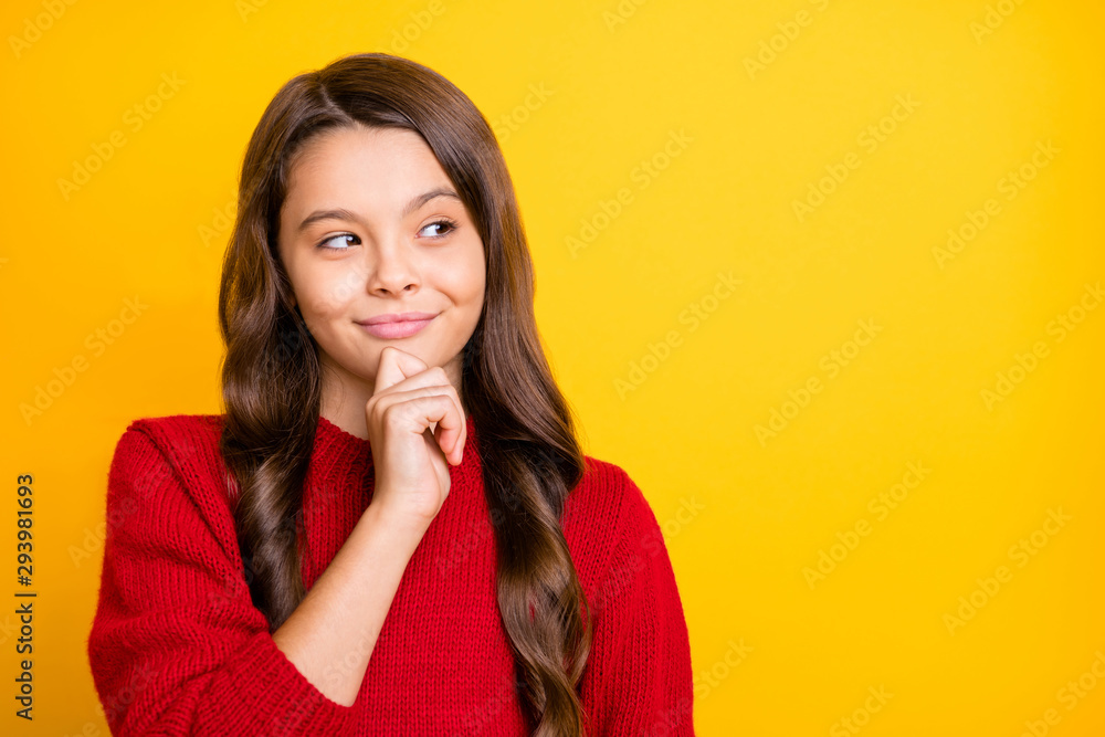 Portrait of interested minded cunning sly model kid think plan tricks for her friends wear style pullover isolated over yellow color background Portrait of interested minded cunning sly model kid think plan tricks for her friends wear style pullover isolated over yellow color background