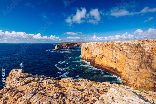 Portuguese coast, cliff into the Atlantic Ocean. Taken in Sagres, Faro, Algarve, Portugal. Beautiful coast of Portugal, Sagres. Seagulls flying over the coast of Algarve, Sagres, Portugal.