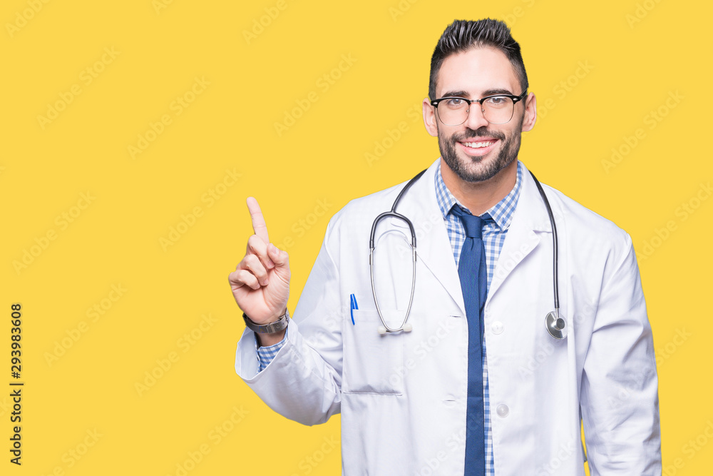 Handsome young doctor man over isolated background with a big smile on face, pointing with hand and finger to the side looking at the camera. Handsome young doctor man over isolated background with a big smile on face, pointing with hand and finger to the side looking at the camera.