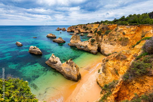 View of stunning beach with golden color rocks in Alvor town , Algarve, Portugal. View of cliff rocks on Alvor beach, Algarve region, Portugal. photo