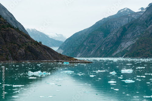 Blue ocean water with ice floes on the background of beautiful mountain views