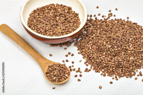 buckwheat in a plate and in a wooden spoon