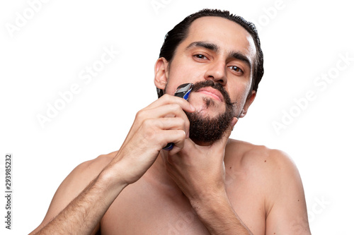 Handsome bearded man with mustache trimming standing bare isolated over white background.