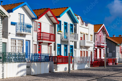 Street with colorful houses in Costa Nova, Aveiro, Portugal. Street with striped houses, Costa Nova, Aveiro, Portugal. Facades of colorful houses in Costa Nova, Aveiro, Portugal.