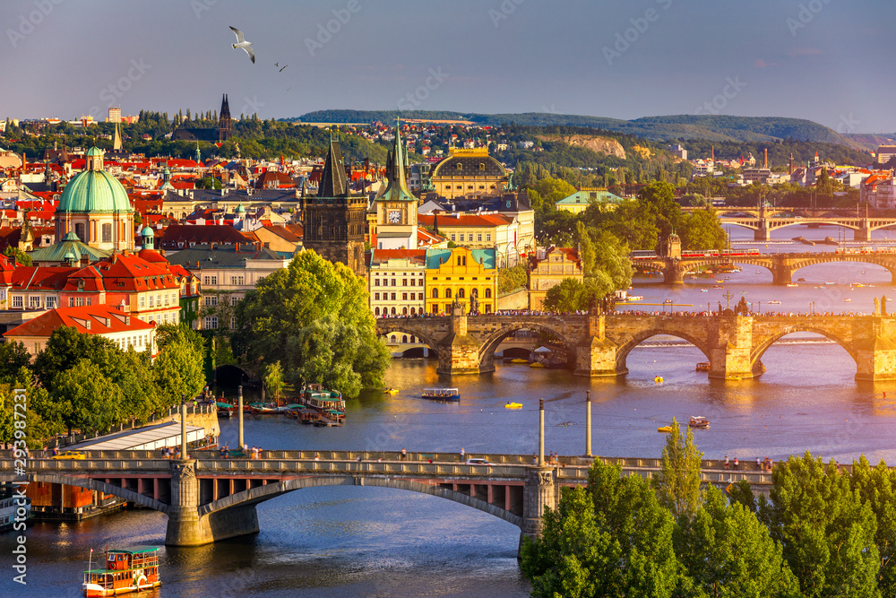 Old Town pier architecture and Charles Bridge over Vltava river in Prague with seagulls, Czech Republic. Prague iconic Charles Bridge (Karluv Most) and Old Town Bridge Tower at sunset, Czechia.