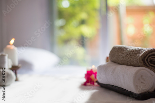  Spa treatments on White spa massage bed with candles, massage oil and Herbal massage cubes