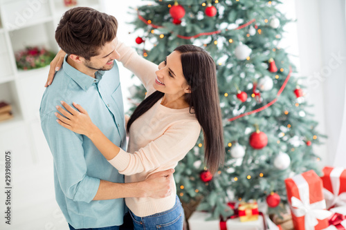 Top high angle photo of two charming romantic people dance enjoy christmas time x-mas vacation in house with evergreen fir tree and giftboxes indoors © deagreez